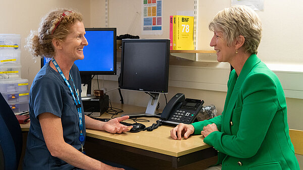 Pippa Heylings in a GP surgery, the GP is on the left and Pippa is sitting to her right